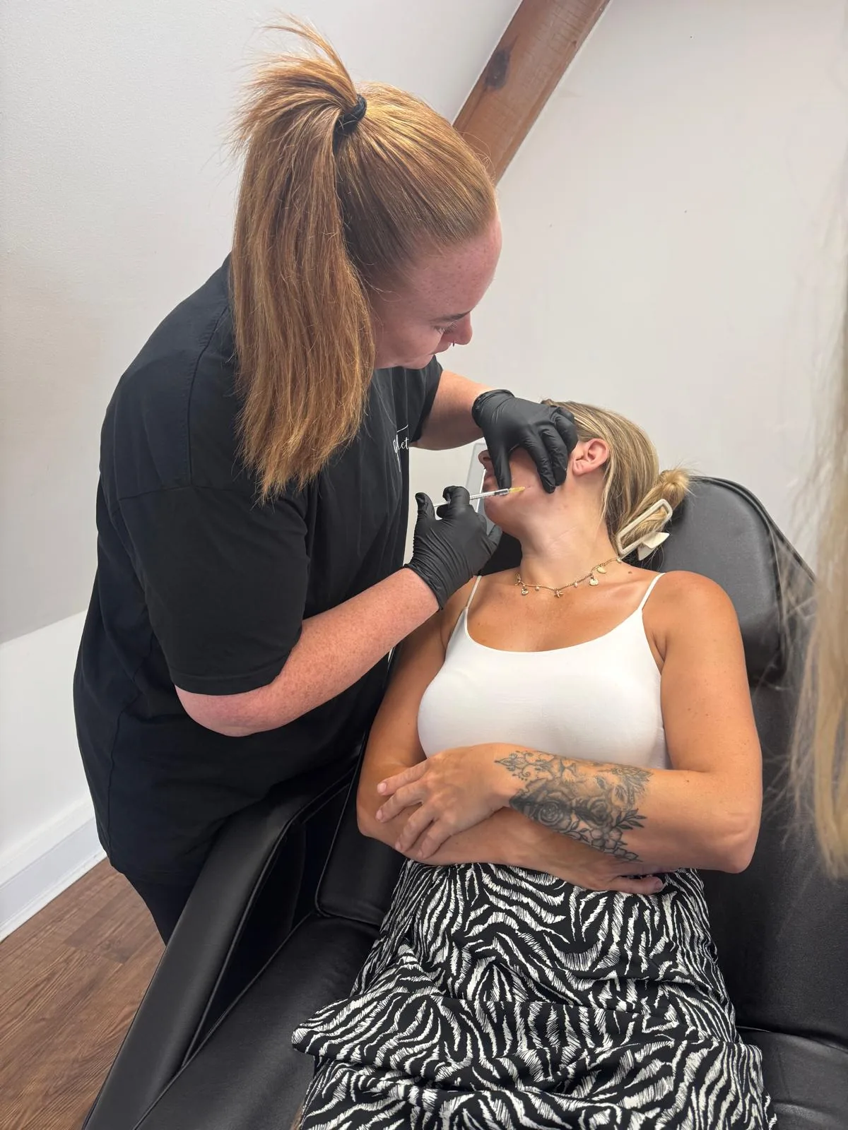 Gemma treating a client at the clinic